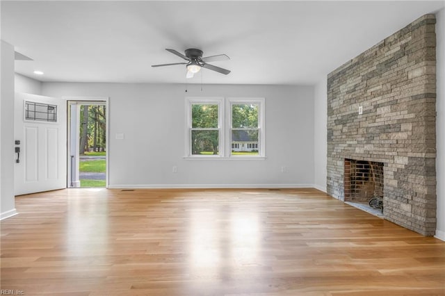 unfurnished living room with a fireplace, light hardwood / wood-style floors, plenty of natural light, and ceiling fan