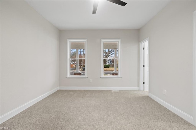 spare room featuring ceiling fan and light carpet