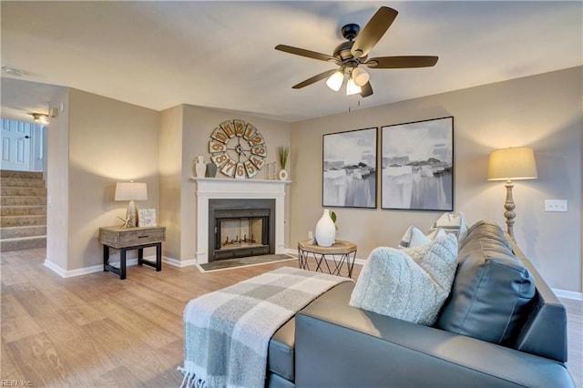 living room with ceiling fan and light hardwood / wood-style flooring