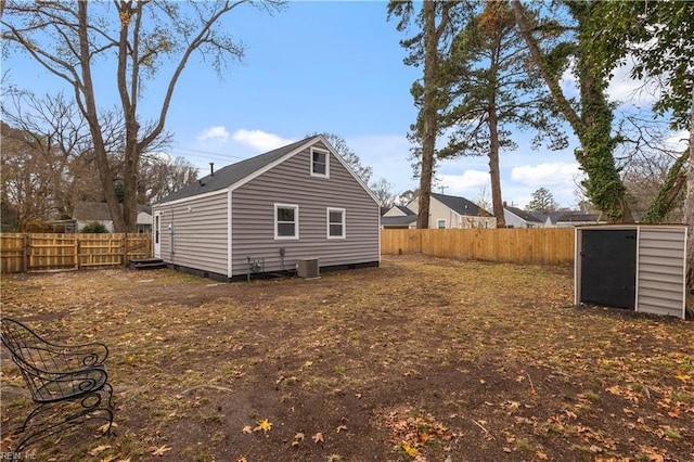 view of home's exterior featuring central AC and a shed