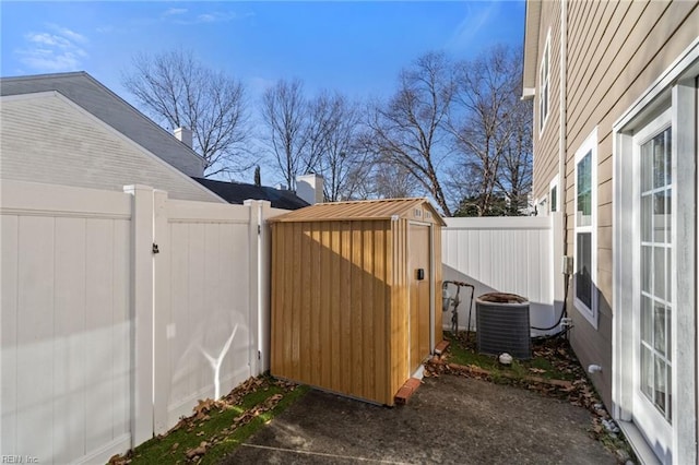 view of yard with central AC and a storage unit