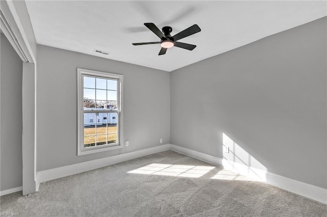 carpeted empty room featuring ceiling fan