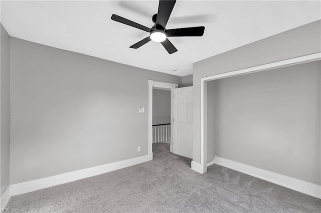 unfurnished bedroom featuring ceiling fan and light carpet