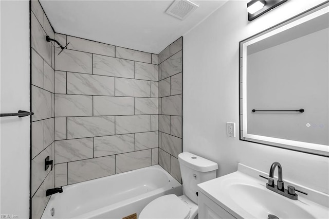 full bathroom featuring tiled shower / bath combo, vanity, and toilet