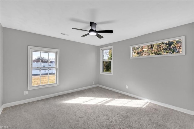 spare room featuring ceiling fan and carpet floors