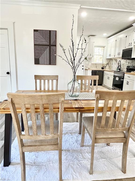 dining space featuring crown molding