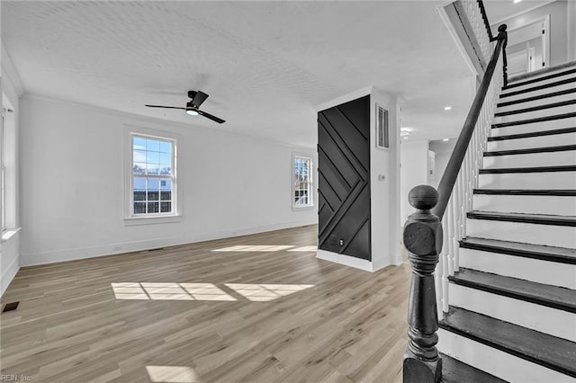 interior space featuring ceiling fan, ornamental molding, and light hardwood / wood-style flooring