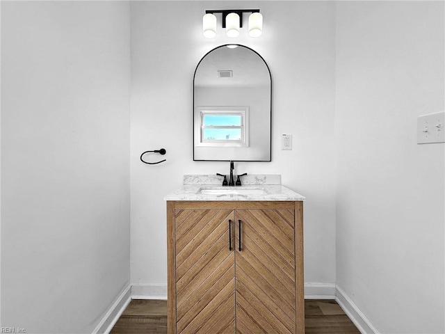 bathroom with vanity and hardwood / wood-style flooring