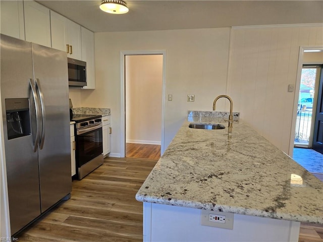 kitchen featuring white cabinets, sink, dark hardwood / wood-style floors, appliances with stainless steel finishes, and light stone counters