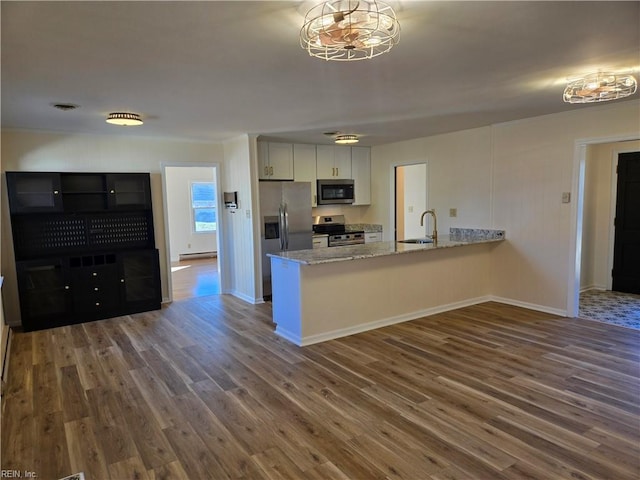 kitchen featuring white cabinets, appliances with stainless steel finishes, and dark hardwood / wood-style floors