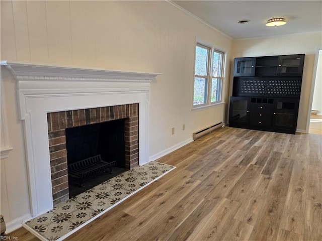 unfurnished living room featuring hardwood / wood-style floors, ornamental molding, a brick fireplace, and a baseboard heating unit