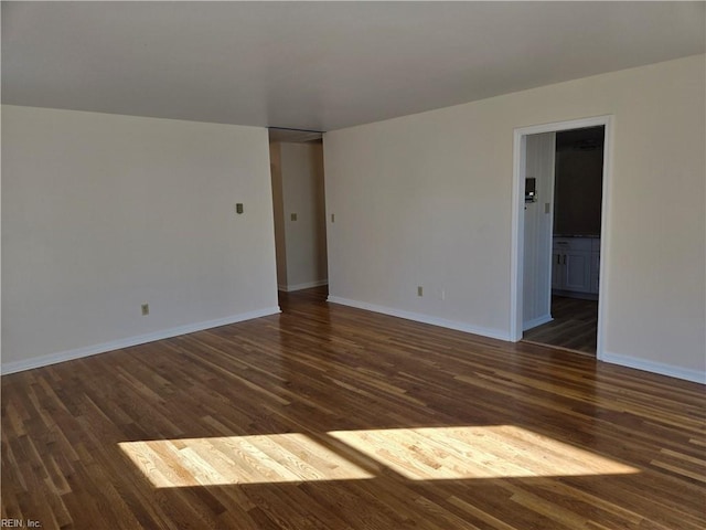 spare room featuring dark hardwood / wood-style floors