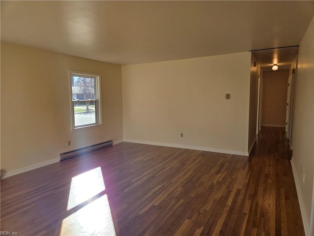 unfurnished room with dark hardwood / wood-style floors and a baseboard heating unit