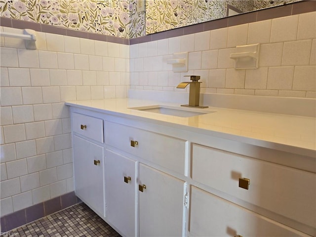 bathroom featuring tile patterned flooring, vanity, and tile walls