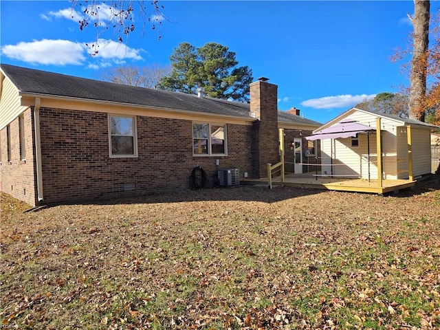 rear view of house featuring central air condition unit and a patio