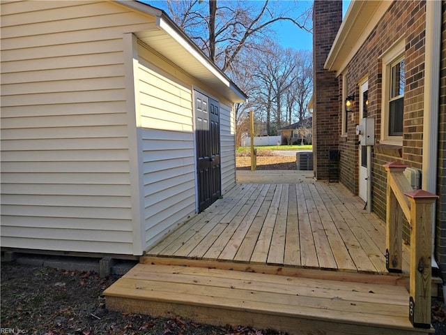 wooden terrace featuring central AC unit