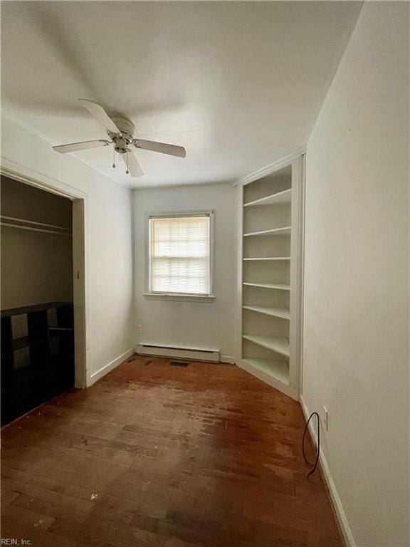 unfurnished bedroom featuring a closet, dark hardwood / wood-style flooring, a baseboard radiator, and ceiling fan