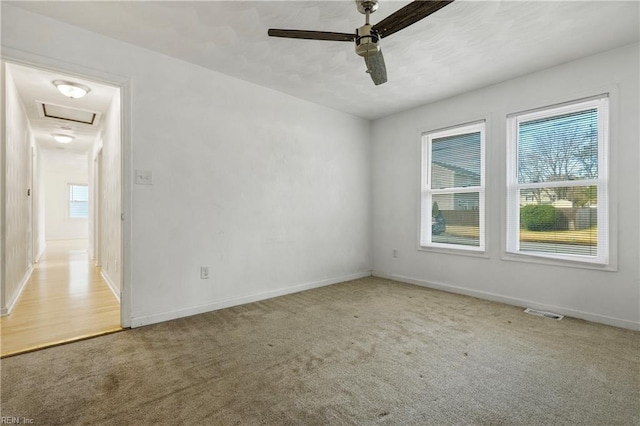 carpeted spare room with ceiling fan