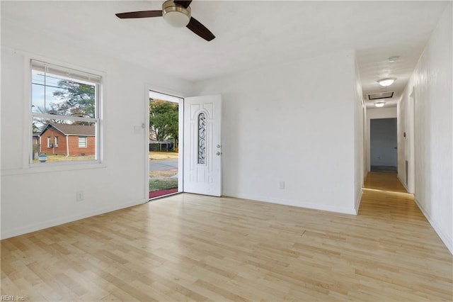 spare room featuring ceiling fan and light hardwood / wood-style flooring