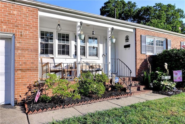 view of exterior entry featuring a porch