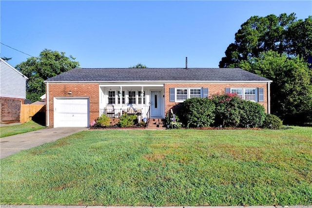 ranch-style house with covered porch, a front yard, and a garage