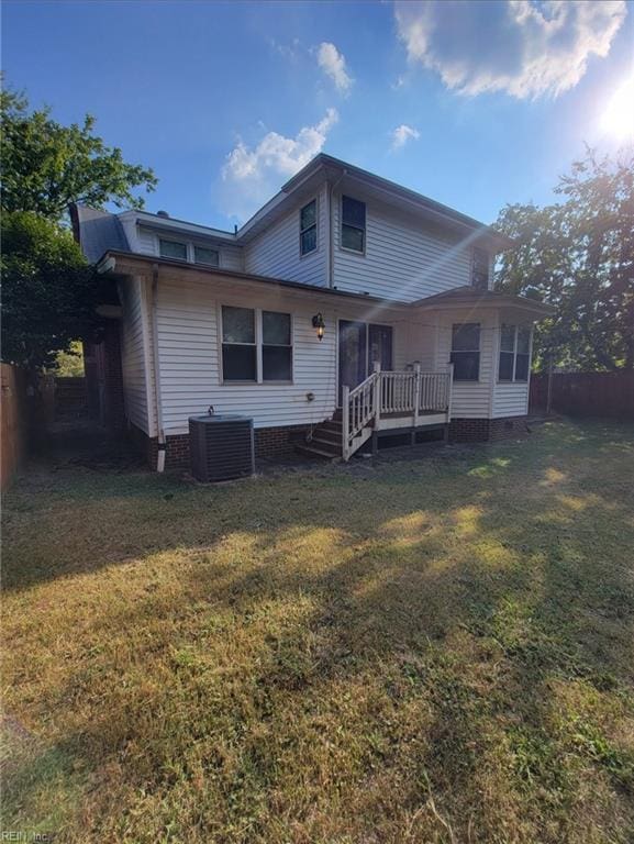 back of property featuring a lawn, central AC unit, and a deck