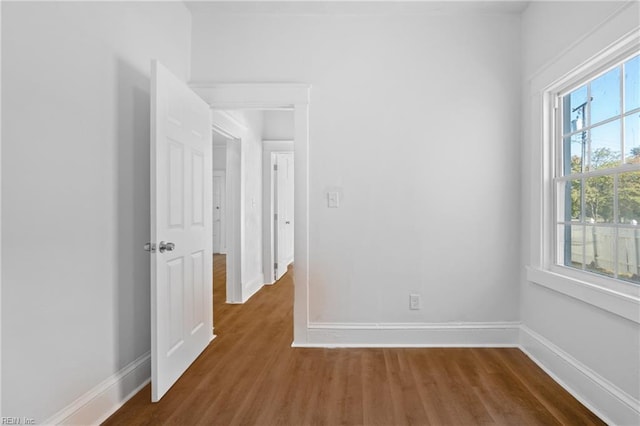 spare room featuring dark wood-type flooring