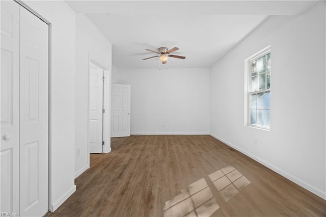 interior space with dark hardwood / wood-style flooring and ceiling fan