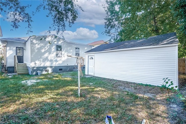 rear view of property with a lawn