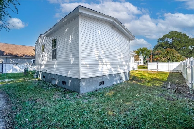 view of home's exterior with a lawn