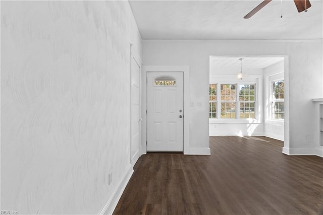 unfurnished living room with ceiling fan and dark hardwood / wood-style floors