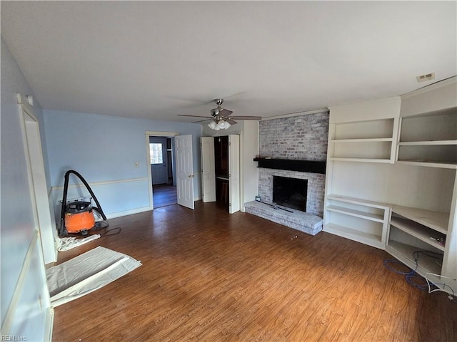 unfurnished living room featuring ceiling fan, a fireplace, and hardwood / wood-style flooring