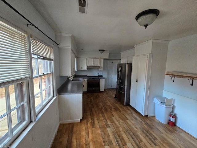 kitchen with white cabinets, sink, stainless steel refrigerator with ice dispenser, dark hardwood / wood-style floors, and range