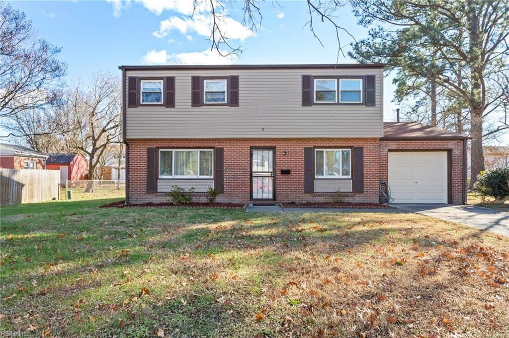 view of front of home featuring a garage and a front lawn