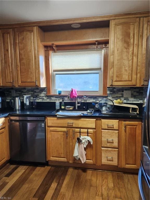 kitchen featuring dishwasher, tasteful backsplash, dark wood-type flooring, and sink