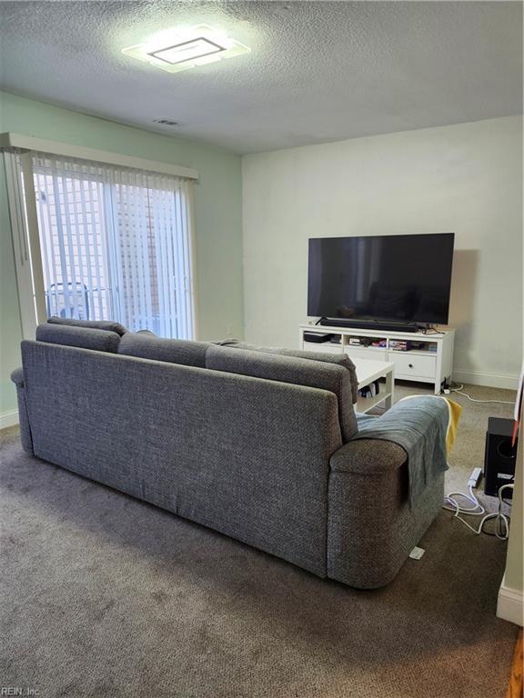 living room with carpet and a textured ceiling