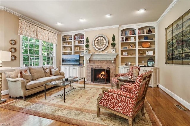 living area featuring a fireplace, hardwood / wood-style floors, and built in features