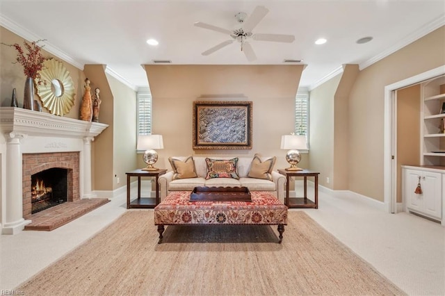 living area featuring light colored carpet, a brick fireplace, ceiling fan, and a healthy amount of sunlight