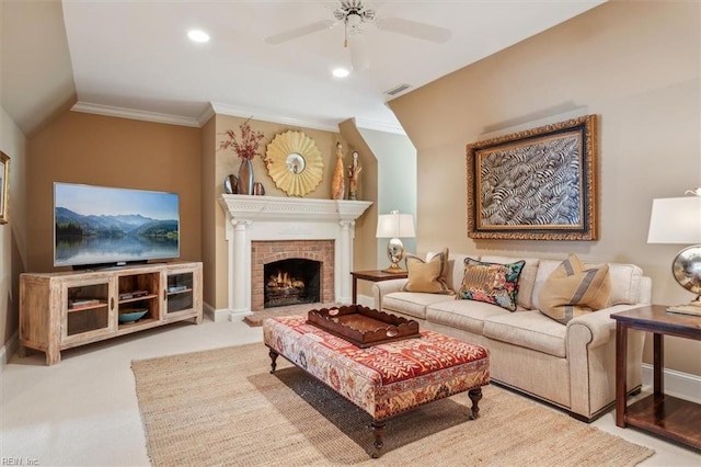 living room featuring a fireplace, ceiling fan, crown molding, and vaulted ceiling