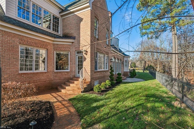 view of side of home featuring a yard