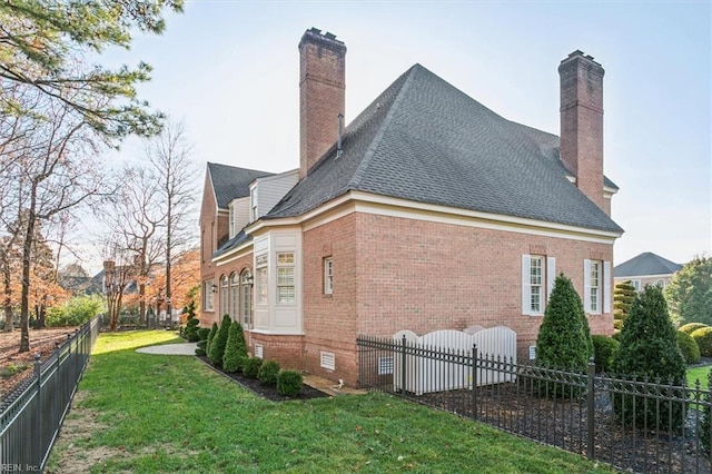 view of home's exterior with a lawn