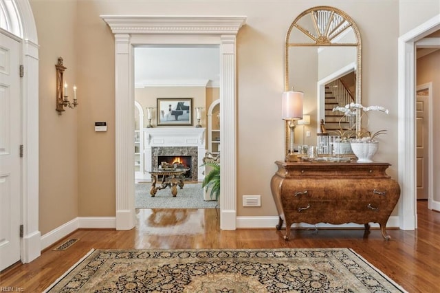 foyer entrance featuring hardwood / wood-style flooring and ornamental molding