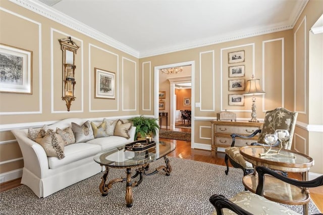 sitting room with hardwood / wood-style floors and ornamental molding