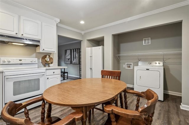 kitchen with white cabinetry, dark hardwood / wood-style floors, white appliances, and washer / dryer