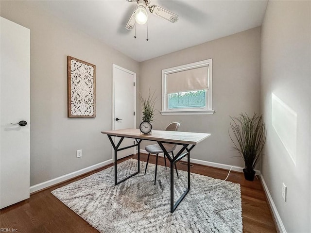 home office with dark hardwood / wood-style floors and ceiling fan