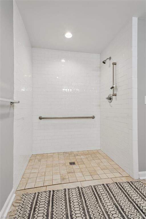 bathroom featuring a tile shower and tile patterned floors