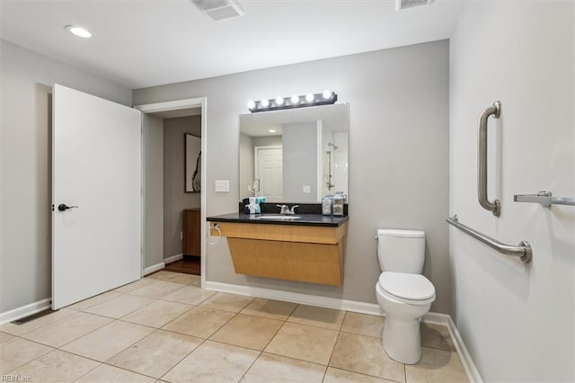 bathroom with tile patterned flooring, vanity, and toilet