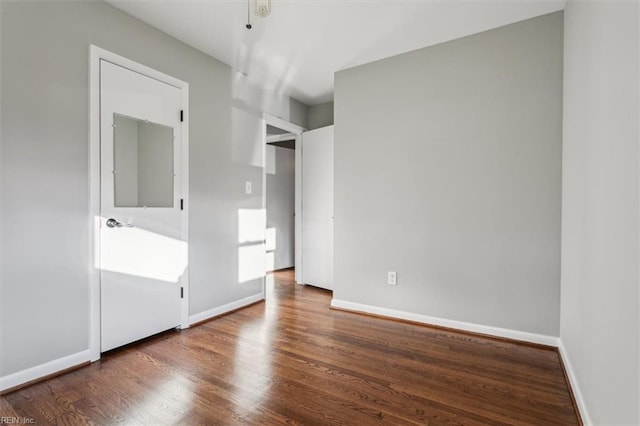 unfurnished bedroom featuring dark wood-type flooring