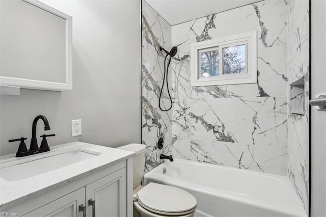 full bathroom with vanity, tiled shower / bath combo, and toilet