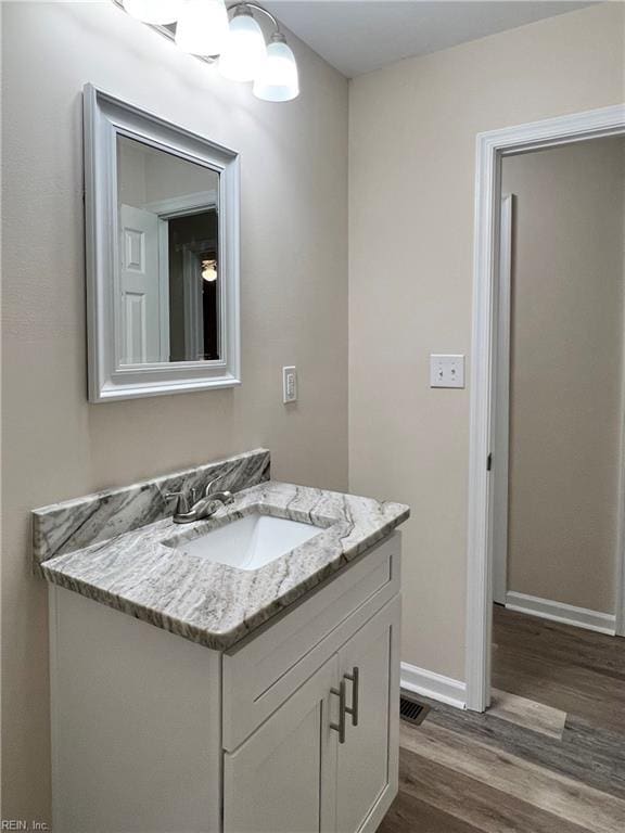 bathroom featuring hardwood / wood-style flooring and vanity